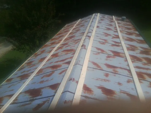 Rusted metal roof panels with new wood purlins before replacement — Storm Damage Roof Repair in Fryeburg by Roofing Brothers